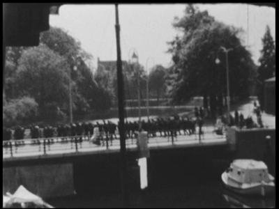 6549BB03943 Beschrijving:00.26.59 Een colonne Duitse soldaten loopt via de Nieuwe Havenbrug het centrum van Zwolle ...