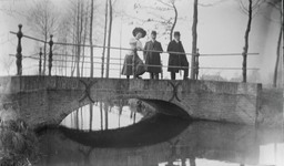 47 Onscherpe afbeelding van twee heren en een dame op een bruggetje over het water., 1910-01-01