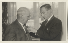 391 50-jarig jubileum van dhr. A. Siekerman Dz., Burgemeester Loggers speldt op 1 april 1962 de versierselen op de borst.