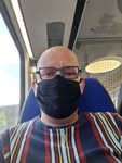 579 Zelfportret van de fotograaf met een mondkapje op in de trein op weg van Zwolle naar Deventer, 30-07-2020